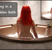 PINUPDAISY: Mädchen mit roten Haaren in großem goldenen Bad Download