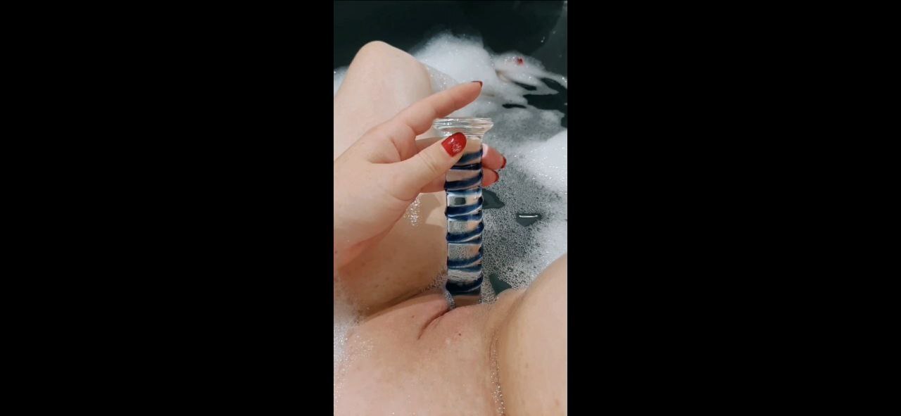 Hot in the tub...used both holes with the glass dildo. Yes, she can do that!