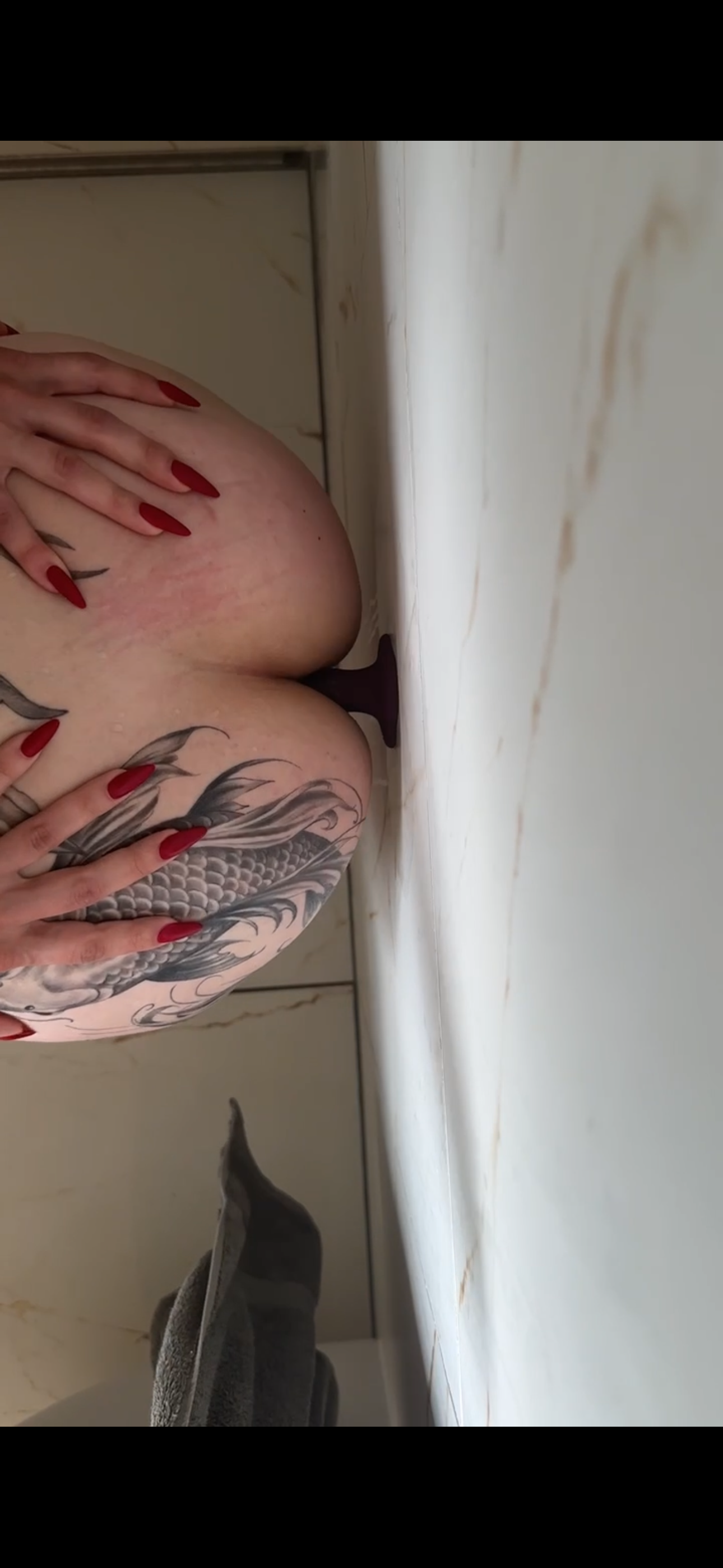 Awesome wall-mounted dildo ride with my tattooed ass – moaning as I rode it to climax.