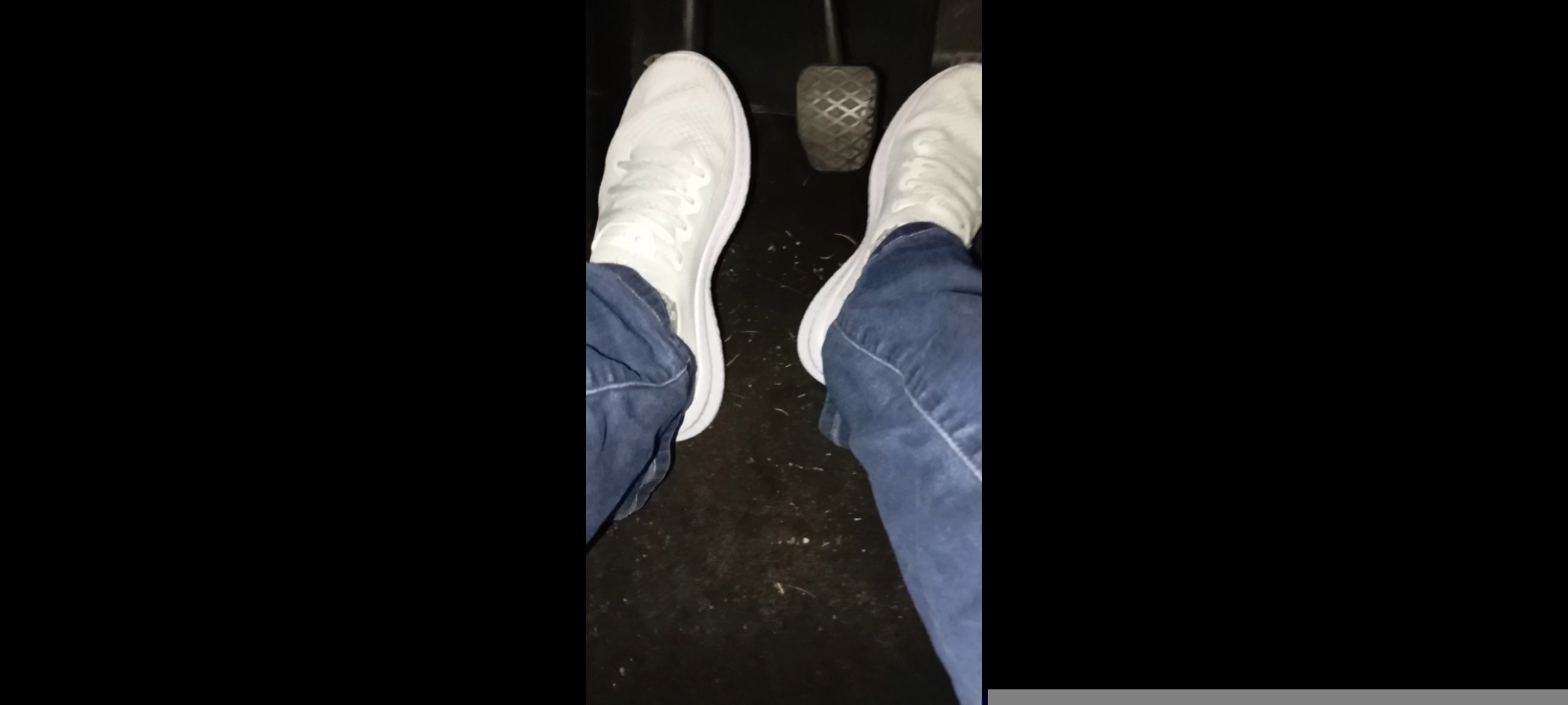 Driving a car in white sneakers. Foot fetish, large pedals.